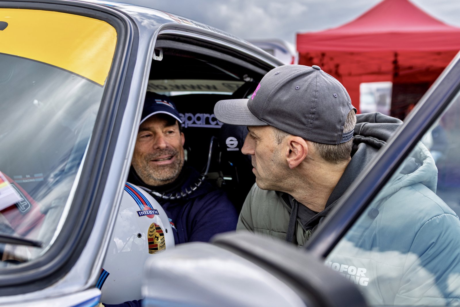 Torsten Kratz talking with a driver in the paddock